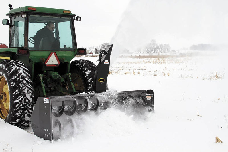 The blower chews through deep drifts and clears to the bare ground. Standard features include hydraulic chute rotation, reversible cutting edge, and adjustable skid shoes